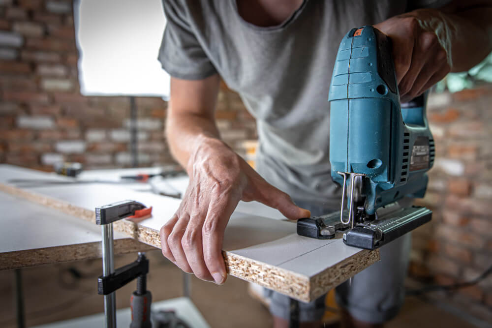 male carpenter cuts wood 